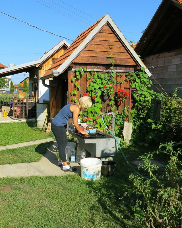 24 Washing Dishes at the Outdoor Sink